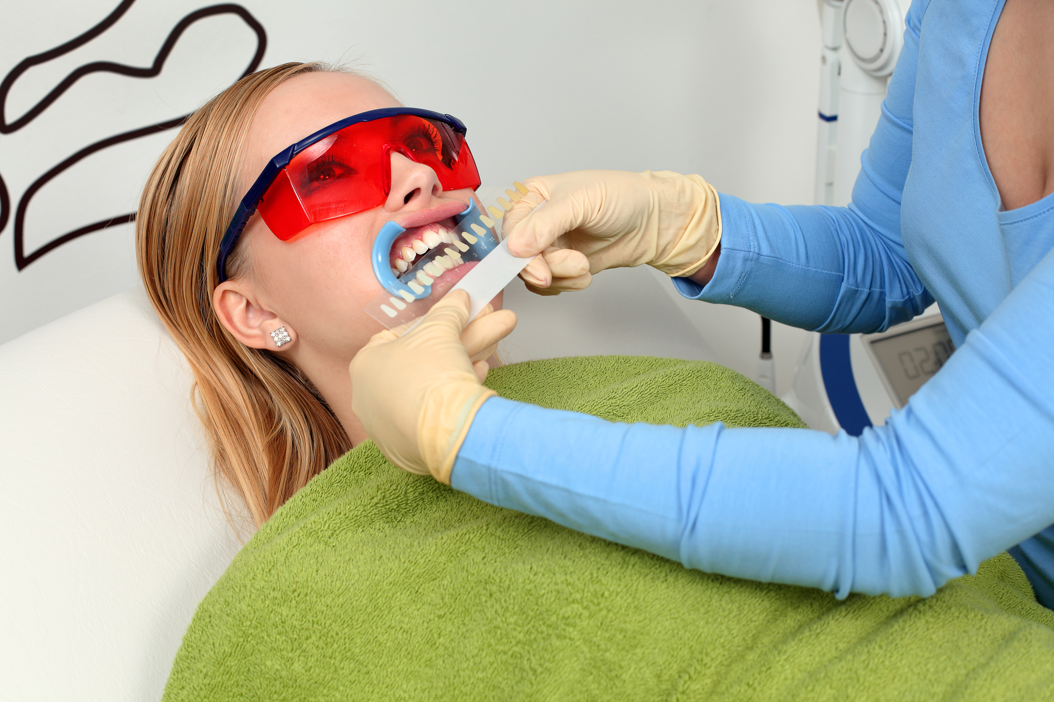 A patient and her dentist about to whiten her teeth