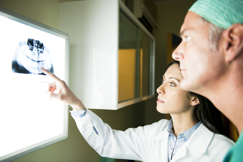 Oral surgeon looking at jaw bone structure