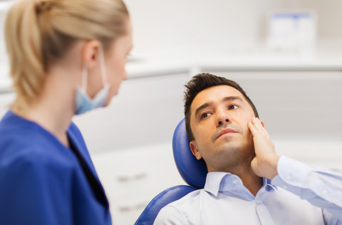 A dentist consulting with her patient