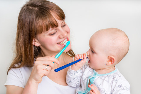 Mum and daughter brushing there teeth together