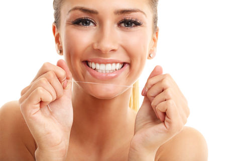 A lady flossing her teeth