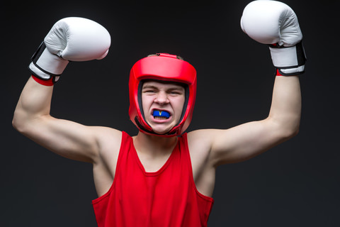 A man using a mouthguard while boxing