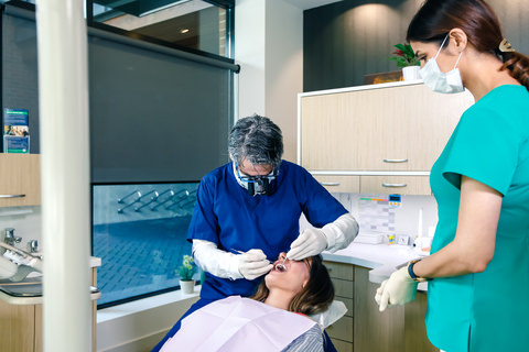 A dentist removing a temporary filling