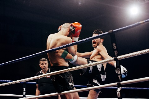 Two man fighting in a ring