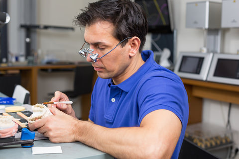 A dental technician in a dental lab