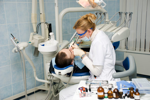 A dentist treating her patient