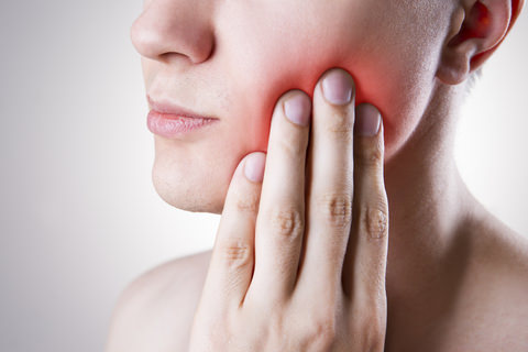 A woman with tooth pain from braces