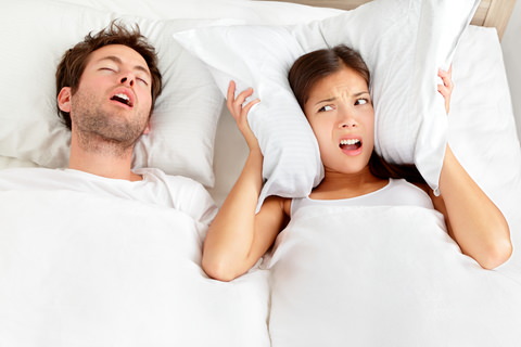 A man snoring loudly next to his partner