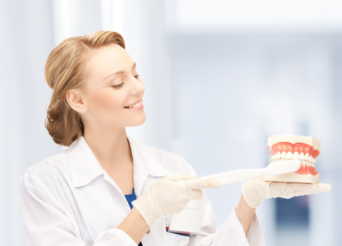 A dental Hygienist showing how to brush