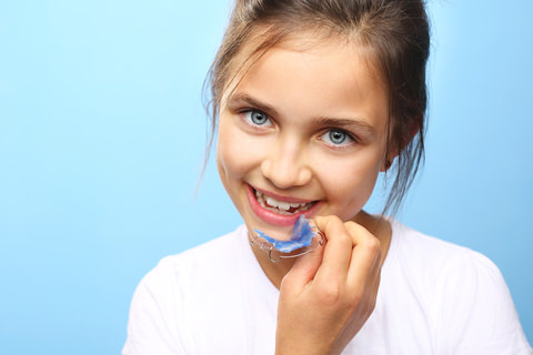 A girl with a dental plate