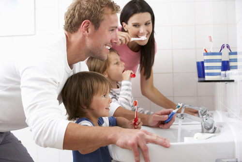 A family brushing their teeth together