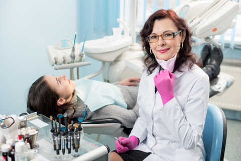 A dentist with a patient in her chair