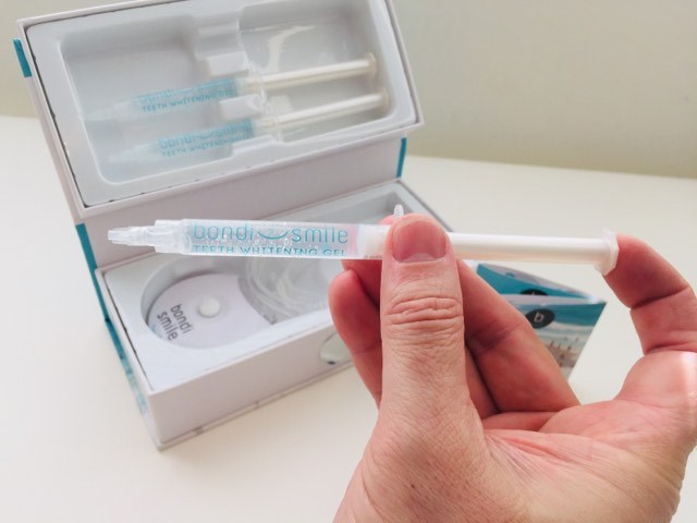 holding the bondi smile whitening gel syringe