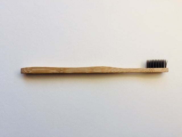 The colgate bamboo charcoal toothbrush on its side