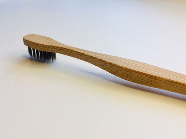 The bamboo Charcoal toothbrush lying down