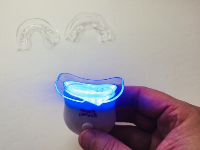 Turning on the LED light in the Kapow Smiles teeth whitening kit