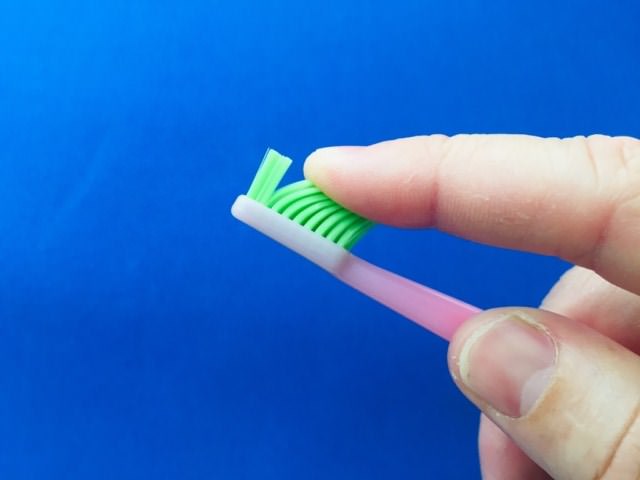 Running my finger over the bristles of the TePe Good™ Compact Toothbrush