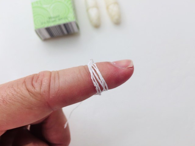 Wrapping the dental lace vegan floss around my finger