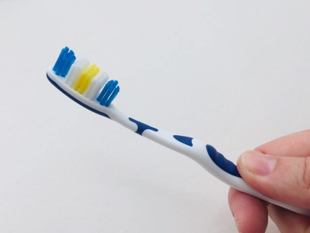 holding the Dentitex Flexi-head toothbrush
