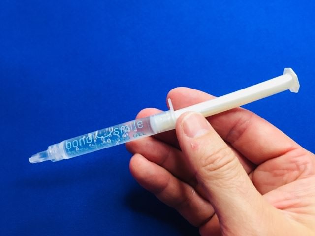 Holding a Bondi Smile Whitening gel syringe
