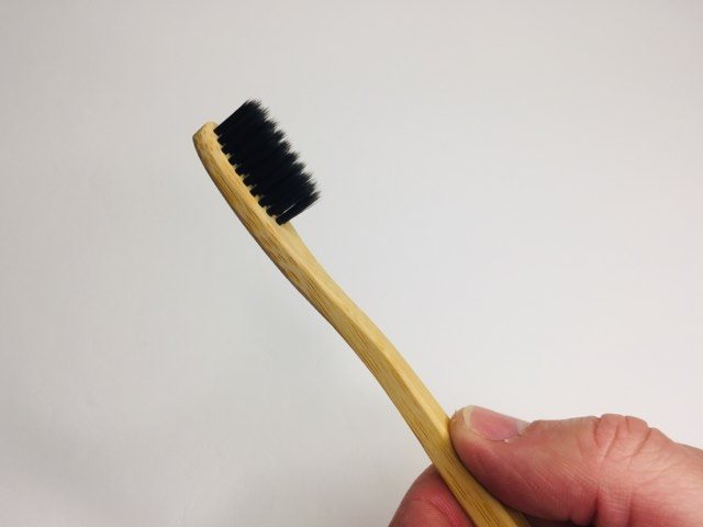 Holding a Bamboo Charcoal EcoToothbrush
