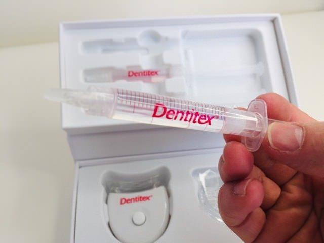 Holiding a dentitex whitening gel syringe