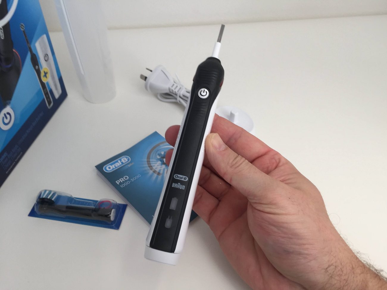 Holding the Oral-B Pro 2 2000 Electric Toothbrush