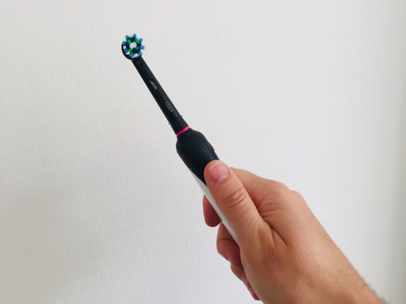 holding the Oral-b Pro 2 2000 Electric Toothbrush