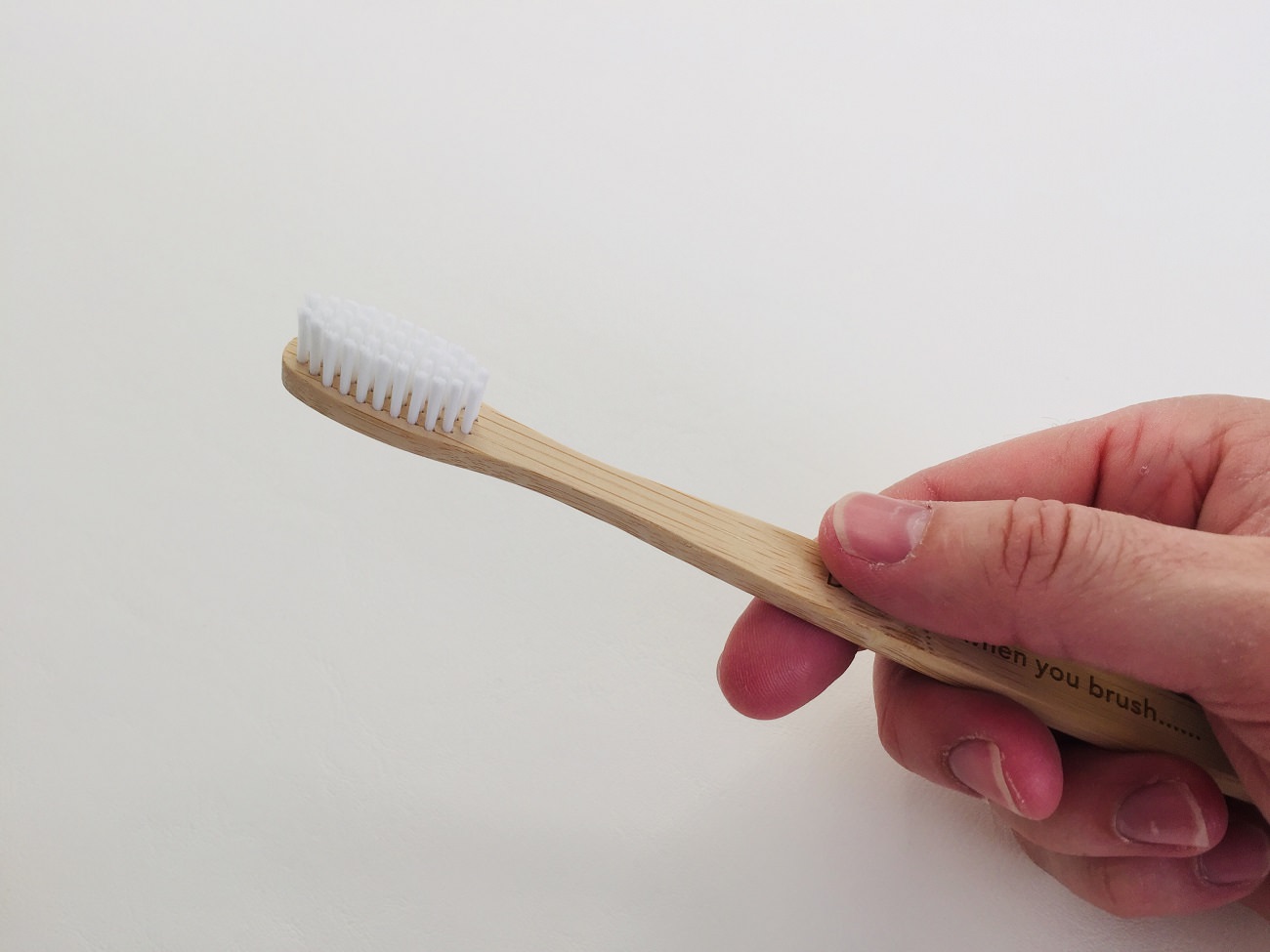 Holding the Flora & Fauna Bamboo Toothbrush