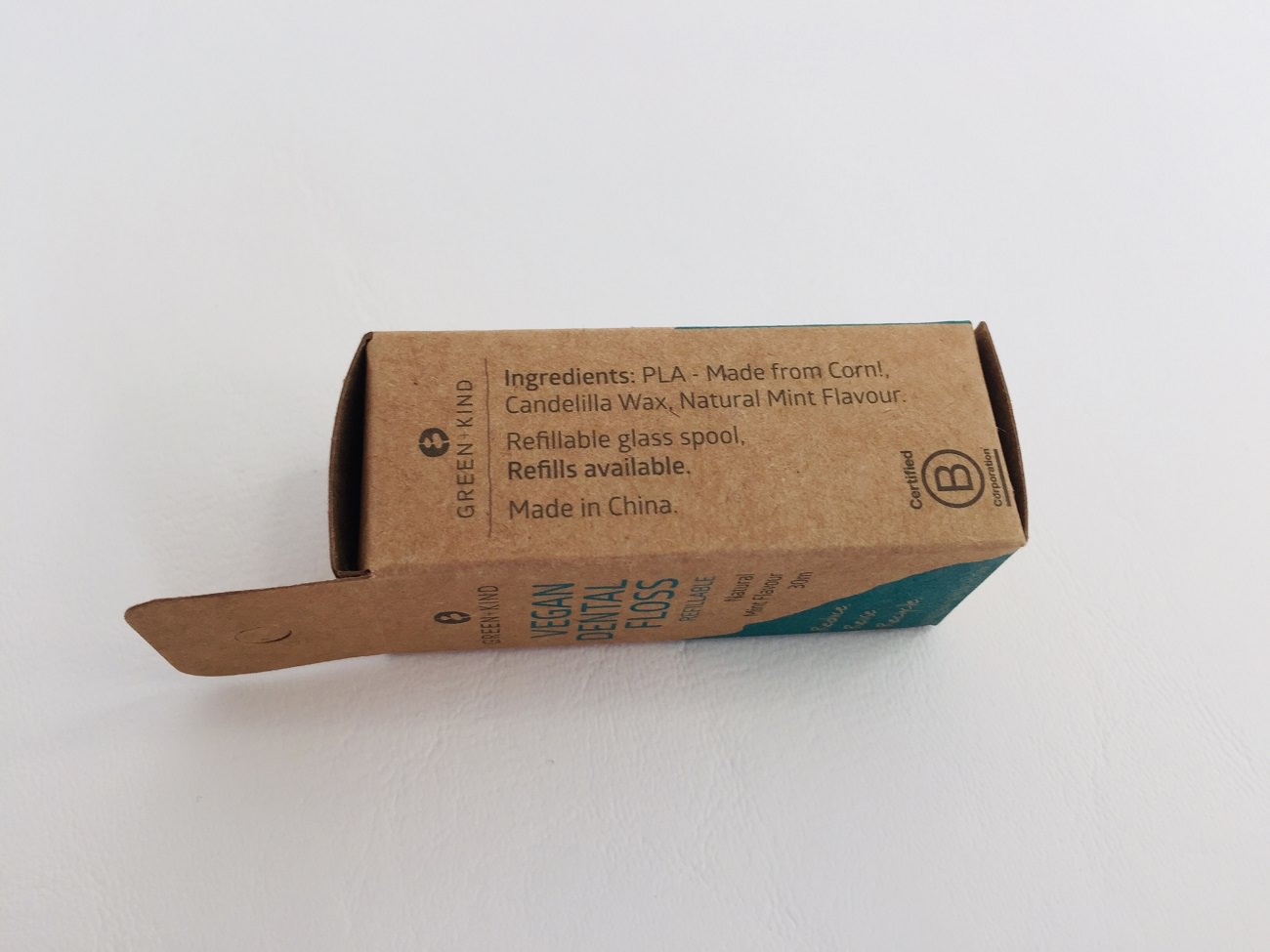 Details of the Green + Kind Vegan Dental Floss on the packaging