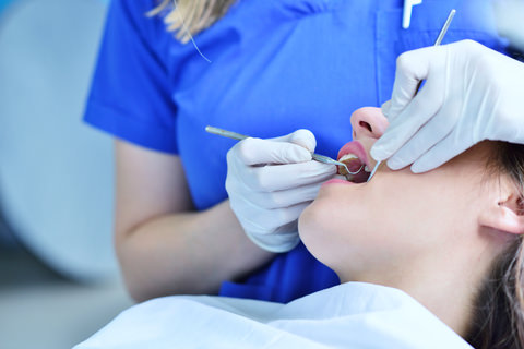 A person having their teeth cleaned by their dentist