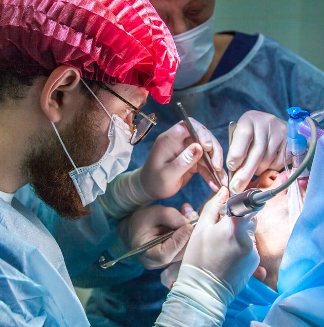 A Doctor performing facial surgery