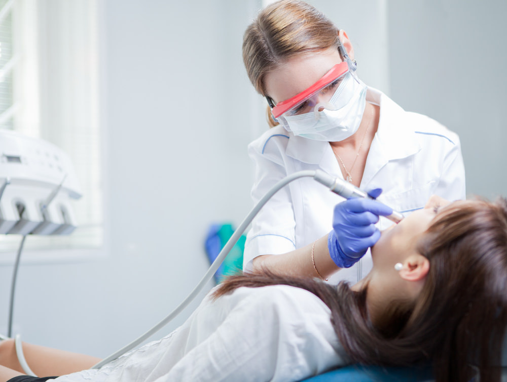 A dental hygienist working