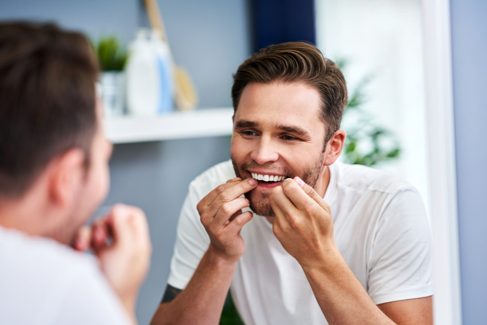 A man using dental floss