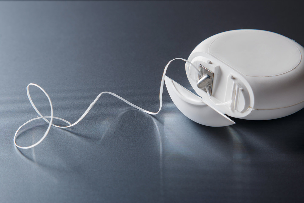 waxed dental floss in a container