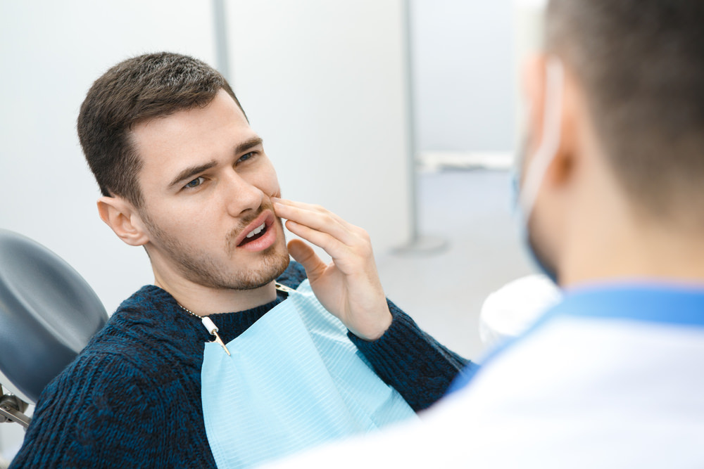 A man seeing his dentist because a toothache