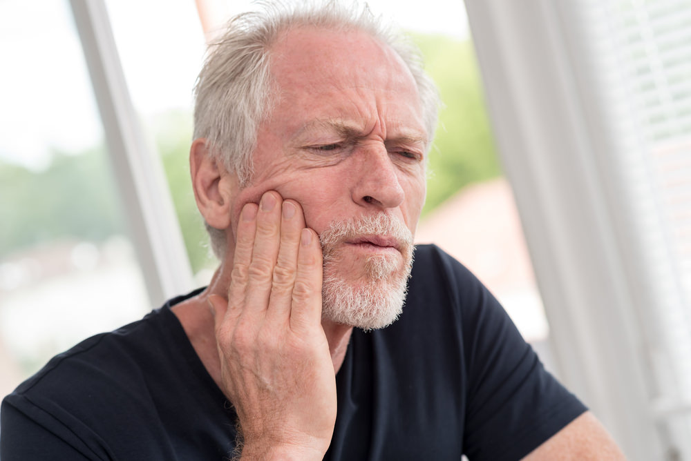 Older man with a toothache