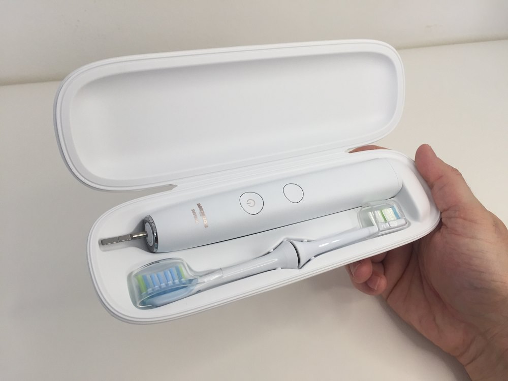 holding the 9000 electric toothbrush travel case with brush and brush heads