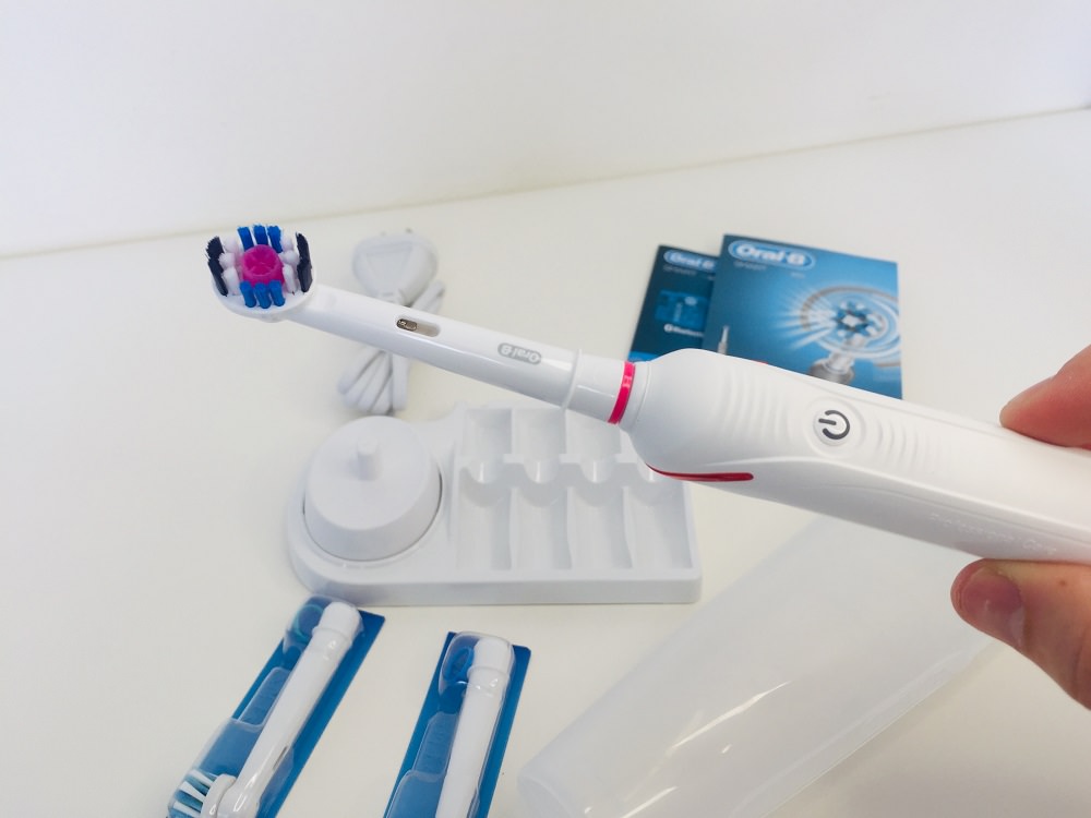 holding the 4000 electric toothbrush by oral b