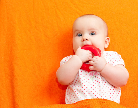 A baby sucking on an object 