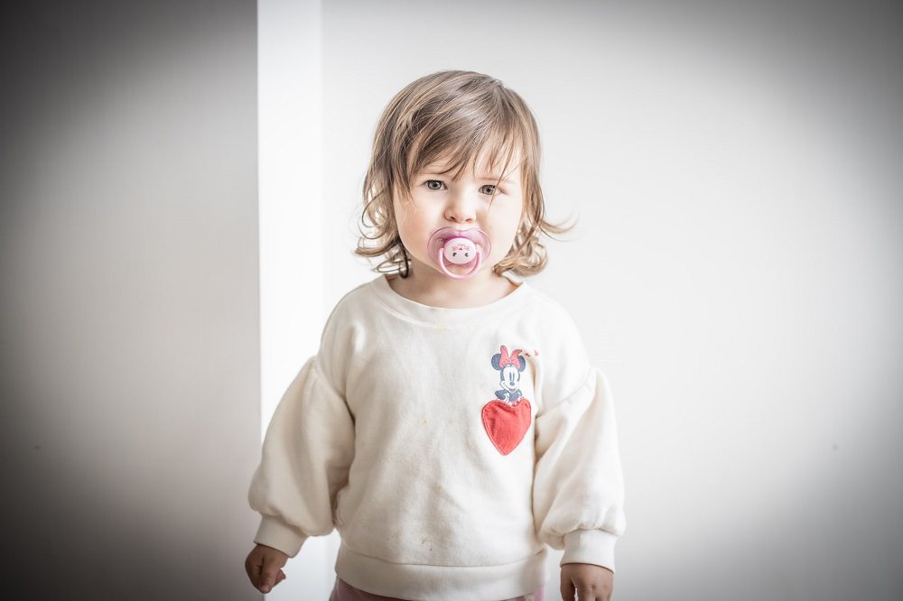 A toddler with a dummy