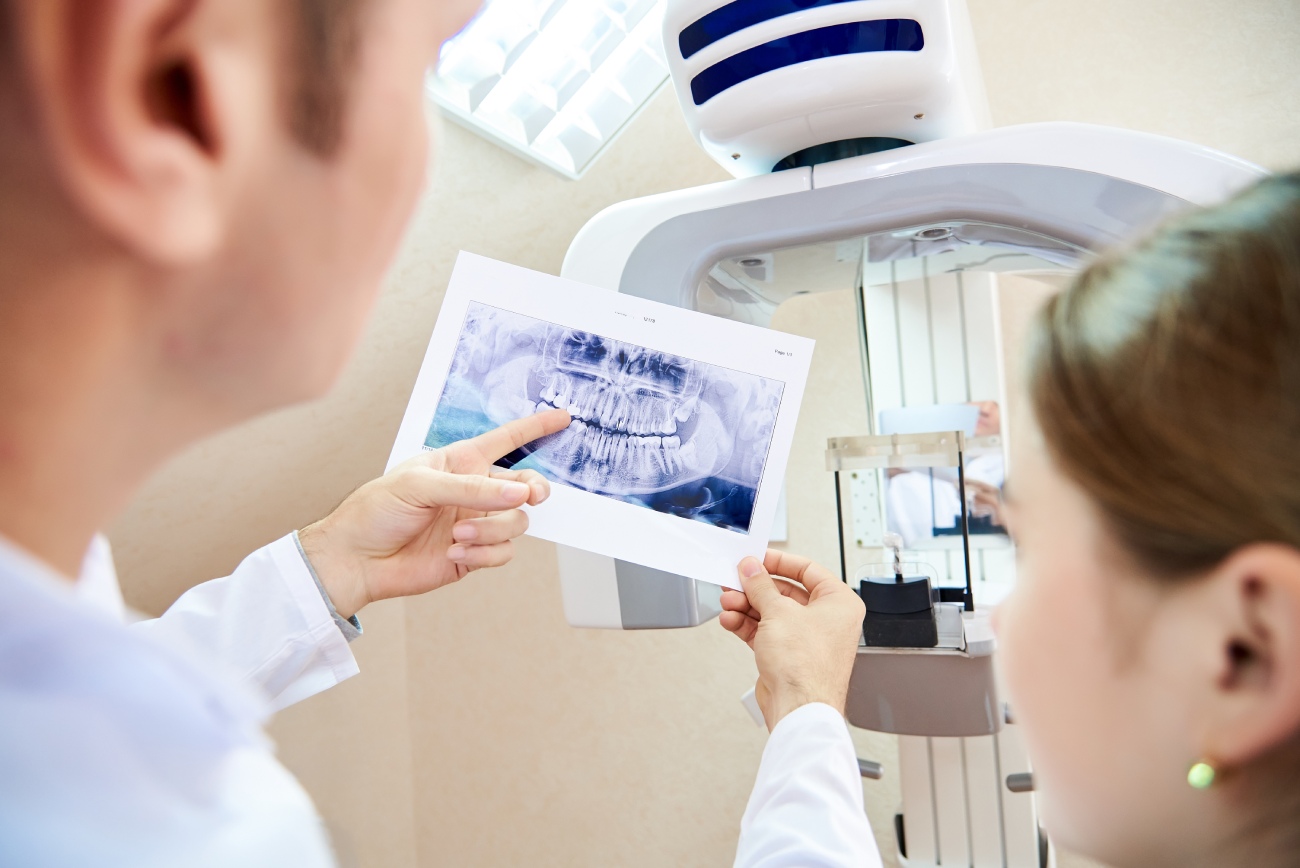 Dentist showing tooth x-ray to patient for dental awareness