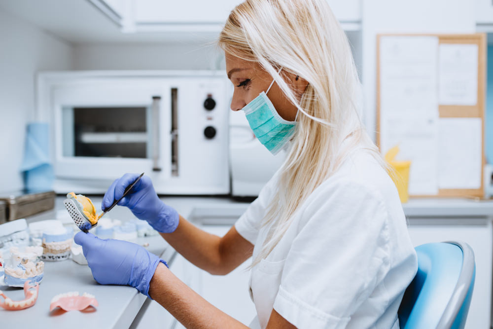 A dental prosthetist working in the lab