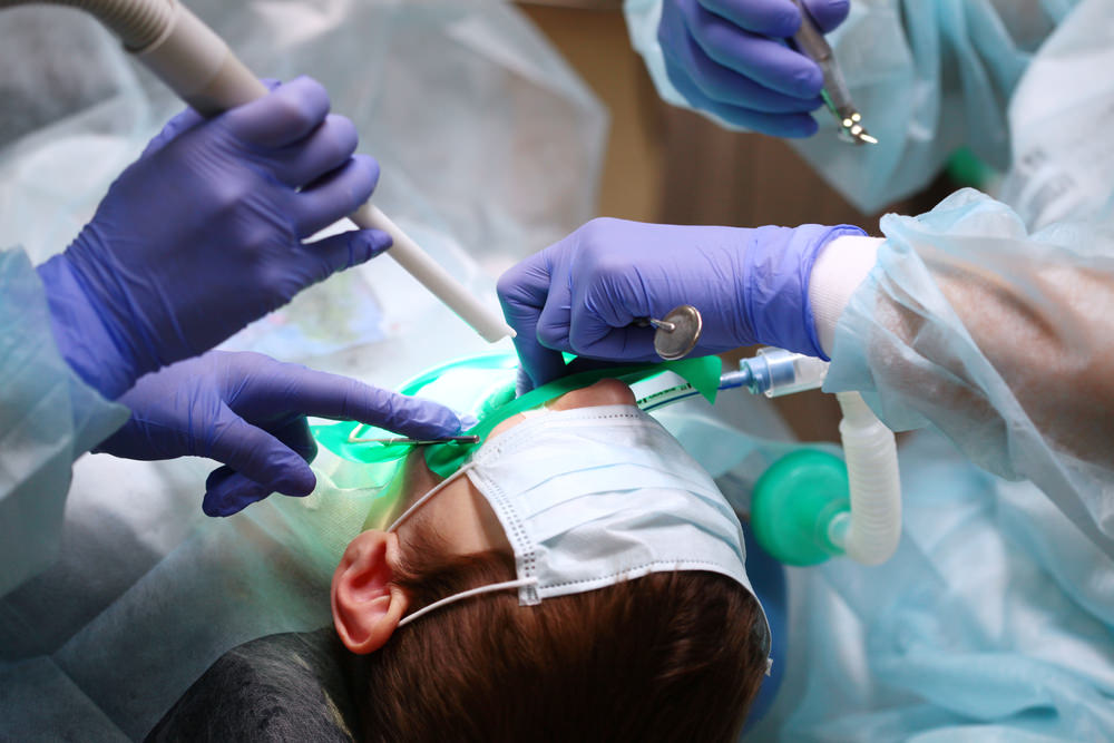 dentists using a dental dam in surgery
